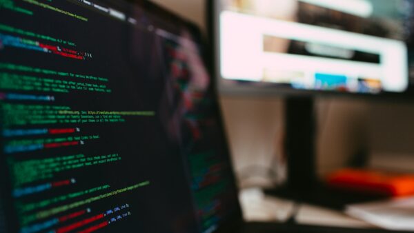A detailed view of programming code displayed on a laptop screen, depicting a tech workspace.